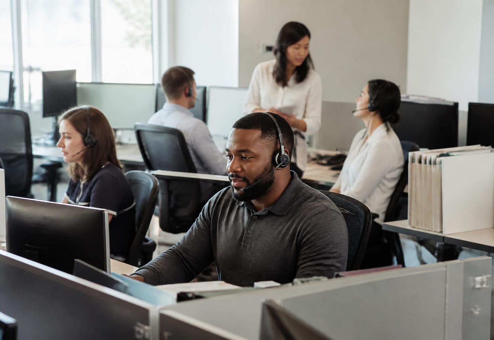 Customer support team working together in an operations center